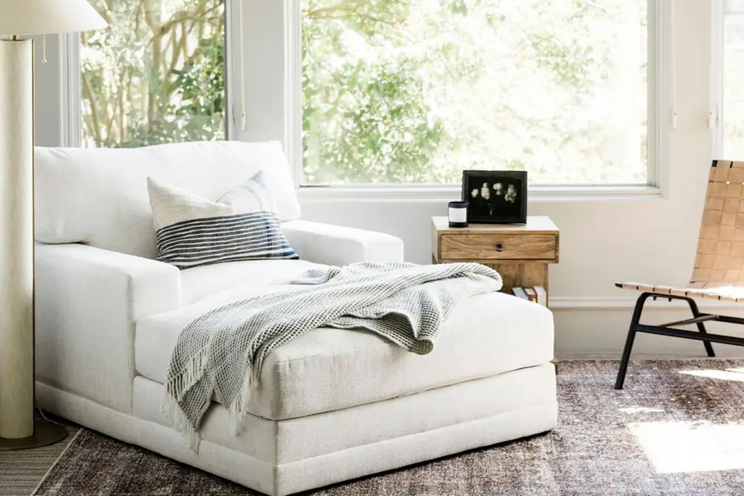 Interior Designers, oversized white chaise lounger chair next to window